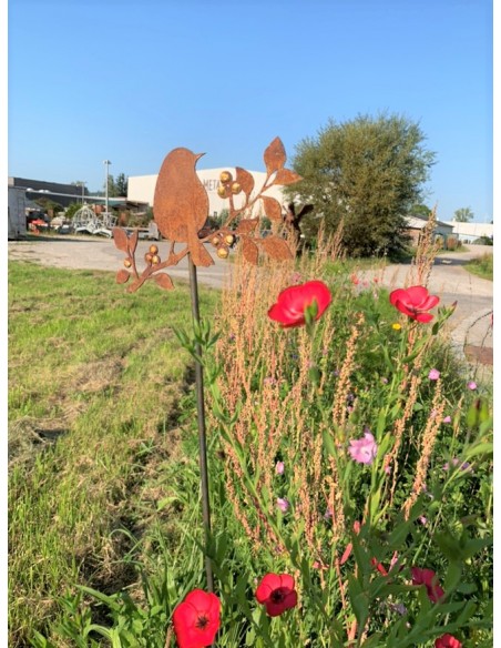 Vogel auf einem Stab sitzend als Gartenstecker und Goldpunkten