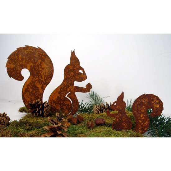 Edelrost Eichhörnchen mit Nuß in der Hand auf Platte