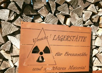 Holzbeige dekorieren mit einem Blechschild aus Edelrost fürs Kaminholzlager